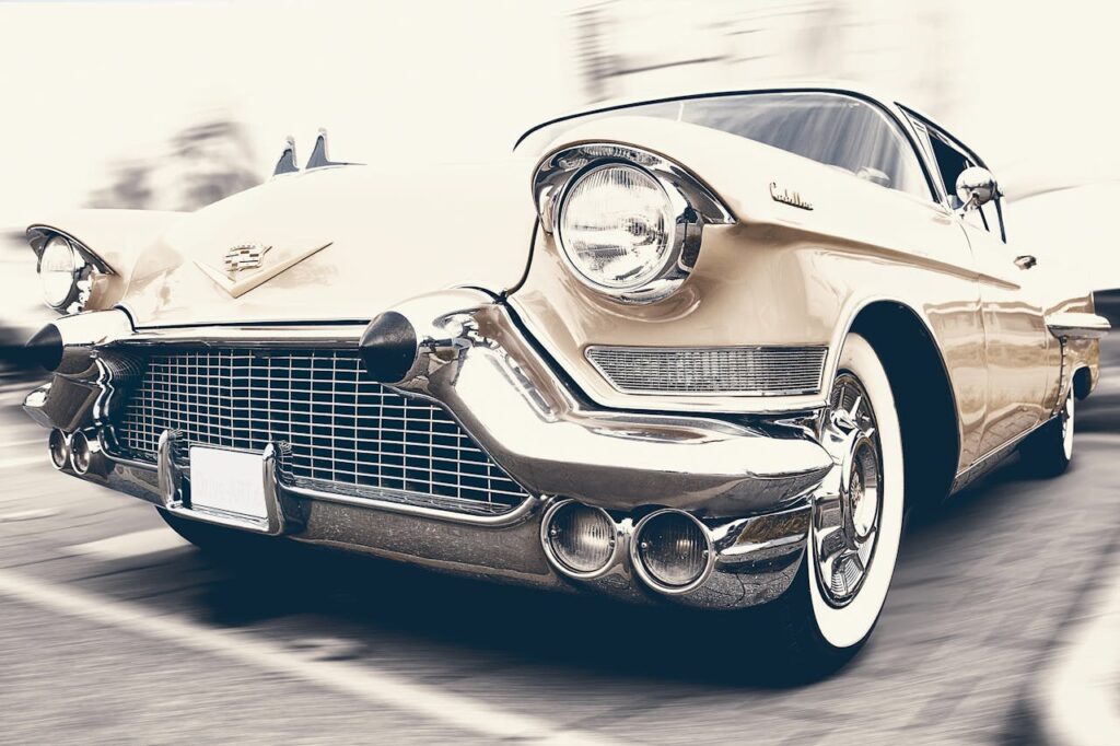 auto car cadillac oldtimer A classic Cadillac captured in motion, showcasing its vintage charm and sleek design.